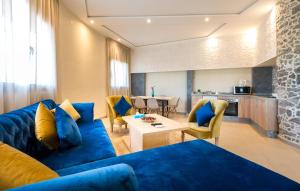 BnB MEDINA في مراكش: غرفة معيشة مع أريكة زرقاء وطاولة