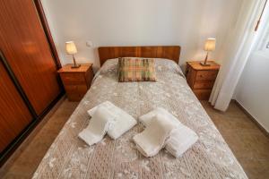 a bedroom with a bed with two pillows on it at Casa Algarvia in Lagos