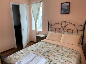 a bedroom with a large bed in a room at Gîte Aux Traditions in Saint-Jean-des Piles