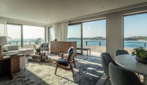 a living room with a view of the ocean at Four Seasons Astir Palace Hotel Athens in Athens