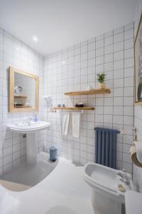 a white bathroom with a sink and a toilet at La Casona de Amandi in Villaviciosa +60 photos