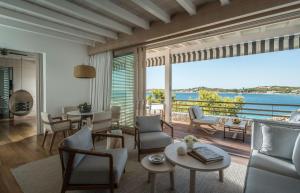 a living room with a view of the ocean at Four Seasons Astir Palace Hotel Athens in Athens