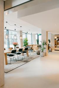 a room with a table, chairs, and a large window at YAYS Amsterdam Docklands in Amsterdam