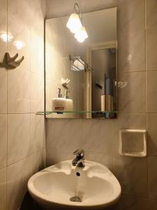 a bathroom with a sink and a mirror at City House 2 in Kalamata