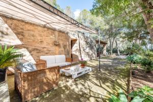 un patio al aire libre con sofá y mesa en Marina Ses Covetes, en Campos