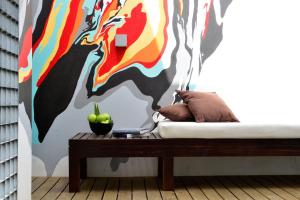 a bedroom with a bed with a colorful wall at Pestana Cidadela Cascais - Pousada & Art District in Cascais