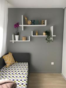 a room with a bed and shelves on the wall at Résidence Nemea, Villeneuve Pont de Bois in Villeneuve d'Ascq