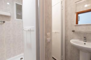 a bathroom with a shower and a sink and a toilet at Pensión Galicia in Canovellas