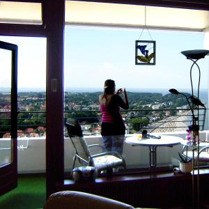 a woman taking a picture of the view from a window at Finke in Travemünde