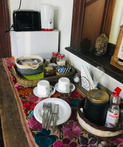 a table with plates and utensils on a table at La Danesa in Ciudad Lujan de Cuyo