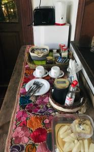 a table with plates and utensils on top of it at La Danesa in Ciudad Lujan de Cuyo +22 photos
