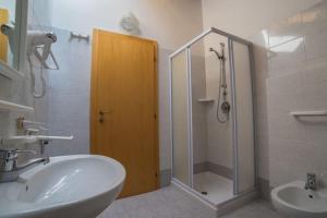 a bathroom with a shower and a sink and a toilet at Casa Silvia in Ledro +74 photos
