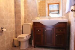 a bathroom with a sink and a toilet at Balcony of Koroni in Koroni +41 photos