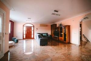 a large living room with a couch and a table at Villa Morada Sonneland con piscina privada climatizada in Maspalomas