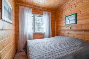 Postel nebo postele na pokoji v ubytování Lomaperkkiö Apartments