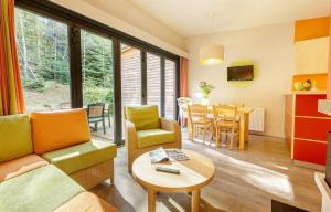 a living room with a couch and a table at Center Parcs Les Trois Forêts in Hattigny