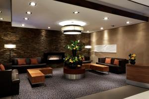 a waiting room with couches and a fireplace at Stamford Bridge Hotel London in London