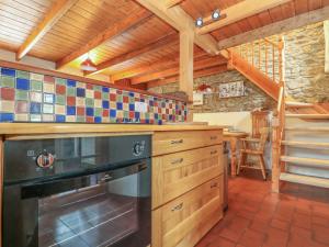 a kitchen with a black stove top oven at Eldamar Cottage in Penryn