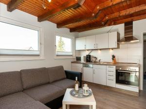 a living room with a couch and a table at Ferienwohnanlage Lübben in Carolinensiel