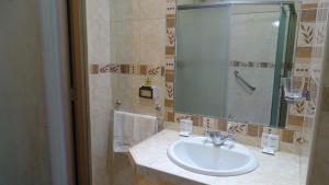 a bathroom with a sink and a mirror at Suites Larco 656 Miraflores Lima in Lima