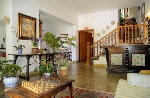 a living room with a chess board on a table at Hostal Los Pinos in Cala de Sant Vicenc