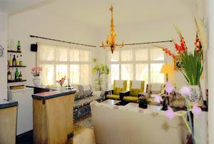 a living room with a couch and a table at Hostal Los Pinos in Cala de Sant Vicenc