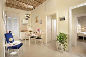 a living room with a table and chairs and a kitchen at La Casina Vaticana in Rome