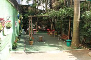 a patio with a playground with tables and chairs at Nomade In Arte e Hostel São Paulo in Sao Paulo