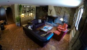 an aerial view of a living room with a couch and chairs at Casa Parranxo in Senterada