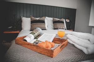 a tray of bread and a glass of wine on a bed at Finest Retreats - The Cotton Rooms in Matlock