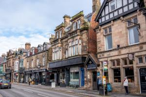 a row of buildings on a city street at Finest Retreats - The Cotton Rooms in Matlock