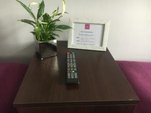 a remote control sitting on top of a table with a box at Hostel Centrum in Września