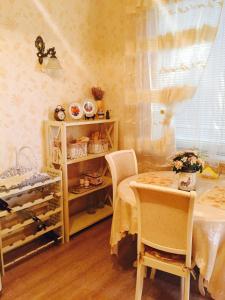 a room with a table and a table and chairs at Красивая 2-ком.кв.,в Новом доме!От хозяйки! in Odesa
