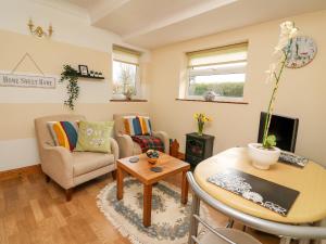 a living room with a couch and a table at Blaenywawr Annexe in Cross Inn