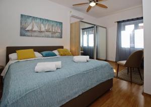 a bedroom with a large bed with two towels on it at Apartments Dubrovnik-Cavtat in Cavtat