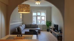 a living room with a couch and a table at City Break Apartments - City Zen in Belgrade