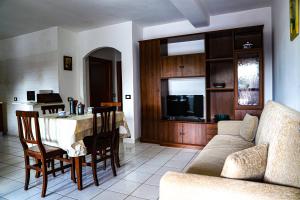 a living room with a table and a couch at Oasi di Cicerone in Formia