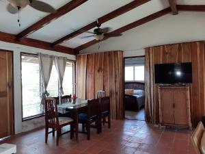 a living room with a dining room table and a television at Dolphin Bay Hideaway in Bocas Town