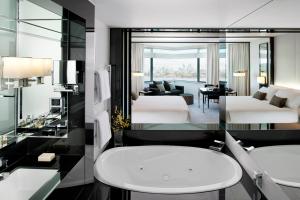 
a hotel room with two sinks and a large mirror at Crown Metropol Perth in Perth

