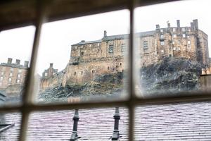 a view of a castle from a window at Grassmarket Apartment in Edinburgh