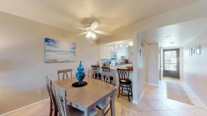 a dining room and kitchen with a table and chairs at Desirable Location, Directly Across Street From South Beach Access!!! in Marco Island