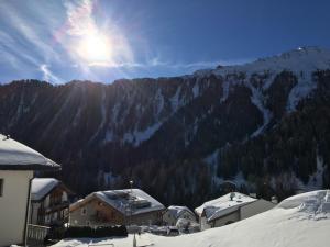 a view of a mountain with snow covered trees and buildings at Suot Crapalb in Samnaun