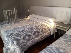 a bedroom with a bed and a side table at Locazione Turistica Le Fate in Agrigento