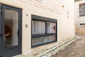 a black door on the side of a building at Chablis SPA : duplex Grand Cru in Chablis