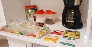 a kitchen counter with a coffee maker and food on it at Cantinho Suico Aluguel de Temporada in Nova Friburgo