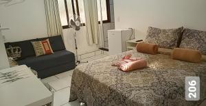 a living room with a bed and a couch at Cantinho Suico Aluguel de Temporada in Nova Friburgo