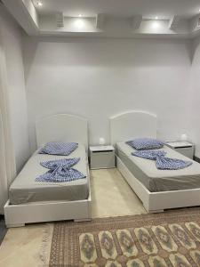 two beds sitting next to each other in a room at Villa avec piscine in Triffa