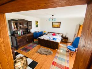 a bedroom with a bed and a blue chair at Libling Štiavnický in Banská Štiavnica