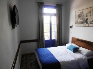 Postel nebo postele na pokoji v ubytování Hôtel Central