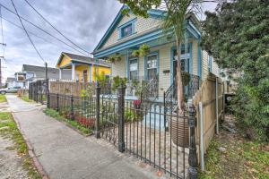 a blue house with a fence in front of it at 5 Mi to Bourbon Street Central NOLA Home in New Orleans